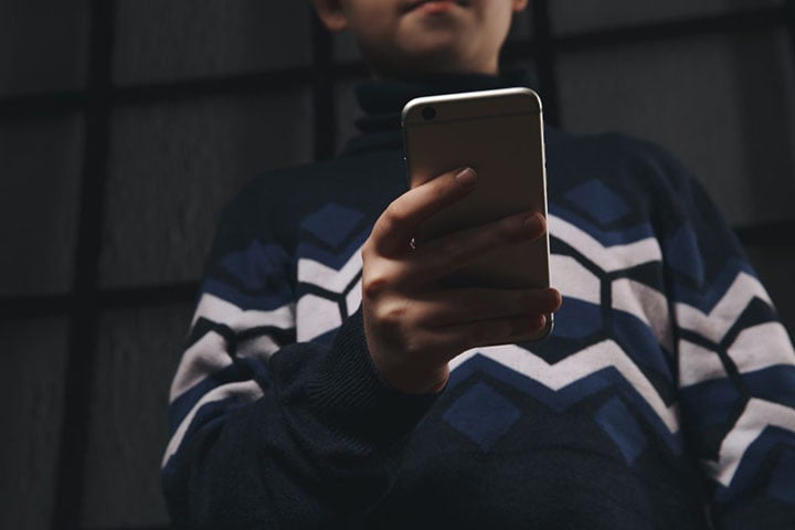 man holding phone doxxing